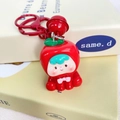 Roter Apfel Cartoon Schlüsselanhänger mit Glocke auf minimalistischen Büchern - Apfel