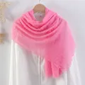 Vibrant pink cotton linen scarf with frayed edges and pleated texture on a white shirt - Hot Pink