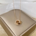 Rose gold double ring necklace with screw pattern on beige jewelry box and silk background - Double Ring Style (8882) / Rose Gold