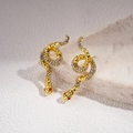 Detailed macro view of snake earrings with sparkling rhinestones and red stone eyes - Snake Rhinestone Stud Earrings (Silver Pin-Gold) / Gold