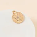 Macro shot of gold plated butterfly pendant with center crystal for jewelry making - Butterfly Round Disc (20#)