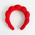 Close-up of a thick red braided sponge headband for face washing and makeup application - Single Headband / Red