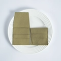 Macro view of olive green suede jewelry pouch showing open and closed states on ceramic tray - Army Green