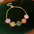 Gold plated bracelet featuring colorful zircon flower pendants on a delicate chain - Colorful