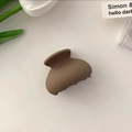 Detail view of a matte coffee brown small hair claw clip styled with elegant tulips - Brown