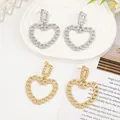 Detail of liquid lava metal heart earrings in gold and silver finish on artistic props - Gold EH014 (Heart Chain)