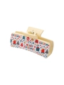 Close-up of beige Christmas hair claw clip with red and green festive patterns - Merry Christmas Tree