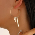 Minimalist gold geometric hoop earrings with vertical bar pendants worn by a model - Large Hoop with Long Bar Pendant Style (0765) / 48 KC Gold