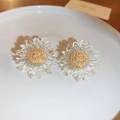 Primo piano di orecchini a girasole trasparenti con anima dorata su piatto di ceramica - Trasparente (Perno in argento)