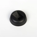 Macro shot of the black round base stand with a molded letter M for jewelry display - Black Base