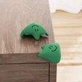 Green L-shaped silicone baby safety corner protector with a smiley face design - Fluid-Green