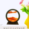 Circular moving sand art glass with orange sand and black frame on a sleek trapezoid base - 5 Inch Round Yellow