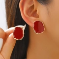 Close-up of irregular red enamel stud earrings with golden alloy edges on ear - KC Gold Red (04 KC Gold Red 3222)