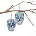 Macro detail of colorful sugar skull earrings with floral patterns on a branch - Sky Blue with Colorful Flowers
