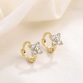 Macro detail of gold four-petal flower earrings with sparkling cubic zirconia on linen - HL-22/Gold Four-Petal Flower Hoop