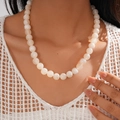 Close-up of white geometric acrylic beaded necklace with vintage marble effect - Necklace / White