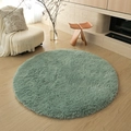 Soft green round plush rug for living room on light wood floor in minimalist style - Cyan