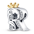 Macro shot of silver letter R charm with golden crown and clear crystal accents - Letter R