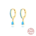 Macro shot of gold S925 silver hoop earrings with blue turquoise teardrop pendants - Gold - Synthetic Turquoise