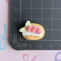 Macro shot of resin strawberry cream cake charm on a measuring mat for size detail - Custard Cream Strawberry Bread