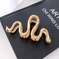 Golden snake metal hair claw clip displayed on a dark book for Halloween dark style - 31# Gold Snake Shape 11cm