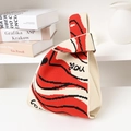 Knit knot handbag featuring a red, black, and beige wavy pattern with 'you' lettering - Red Black Love You