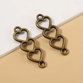 Tre connettori a cuore cavo in bronzo antico per la creazione di gioielli fai da te - Bronzo