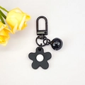 Creative black floral keychain with bell and matte finish flower pendant for bags - Black