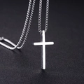 Classic silver stainless steel cross necklace for men on a black textured background - Box Chain / Silver