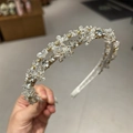 Detail of handcrafted crystal headband with sparkling rhinestones on golden frame - Model B Double Row / Model B Double Row White