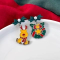 Detail of Christmas earrings featuring golden reindeer and green wreath with pearls - Bow Reindeer & Wreath