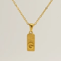 Macro shot of gold stainless steel necklace with sandblasted rectangle G letter pendant - Letter G