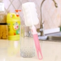Pink long handle sponge bottle brush cleaning a glass cup in kitchen setting - Individual Bag / Large Pink