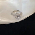 Macro shot of silver ring with large round zircon, pavé diamonds, and adjustable band - 14# Luxury Round Zircon Pave Style