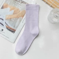 Minimalist lavender purple cotton mid-calf socks for women laid on white desk - Purple