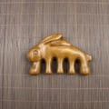 Macro shot of rabbit-shaped sandalwood massage comb with smooth five-tooth meridian design - Golden Sandalwood Rabbit Shape (9.5*6*2cm)