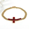 Detail of gold chain bracelet with cross pendant inlaid with red cubic zirconia - Dark Red
