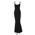 Detail view of the sleek fishtail hem and slim fit silhouette of the black maxi dress - S / Black