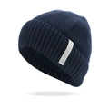 Close-up of deep blue knitted beanie with thick ribbed texture and decorative woven label - One Size / Navy Blue