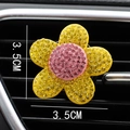 Macro shot of 3.5cm rhinestone flower car vent clip with yellow petals and pink center - Yellow Flower