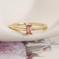 Macro view of gold-plated ring with a rectangular pink gem and zircon accents - Adjustable Open / Pink