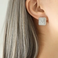 Silver square stud earrings with heart-shaped zircon inlay shown on a model - Silver White Zircon Stud Earrings