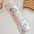 Close-up of ten colorful heart-shaped hair clips arranged on a white jewelry display card - 4-Heart