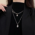Detail view of double-layered silver OT buckle necklace with irregular geometric pendants - Double Layer Irregular