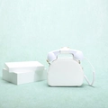 Detailed close-up of a creative white telephone-shaped handbag on a light green background - White