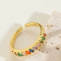 Macro detail of gold-plated crescent ring featuring a row of vibrant colorful gemstones - Colorful Zirconia Style 1 (JZ0375-4)
