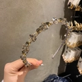 Detailed view of handmade crystal beads and gold prongs on luxury velvet headband - Smoke Gray