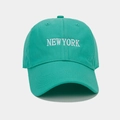 Close-up of NEW YORK white embroidery on high-quality green cotton baseball cap - Teal