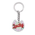 Pink cartoon horseshoe keychain in light green PVC rubber with red Lucky lettering - Lucky Horseshoe