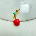Close-up of a cherry brooch with red enamel and gold stem with a green crystal leaf - Style 17 Enamel Green Leaf Red Cherry